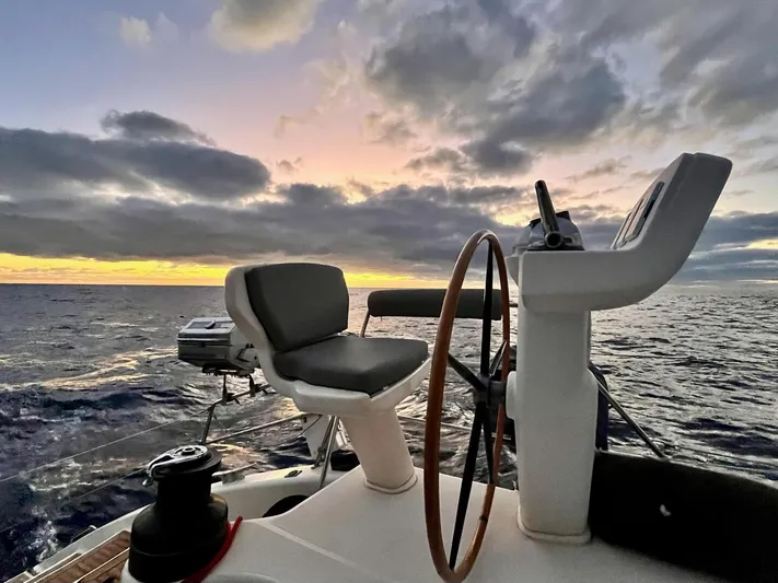 Mersea Yacht Photos Pics Catana 582 yacht helm at sunset, 2001 model, ocean view with dramatic clouds.