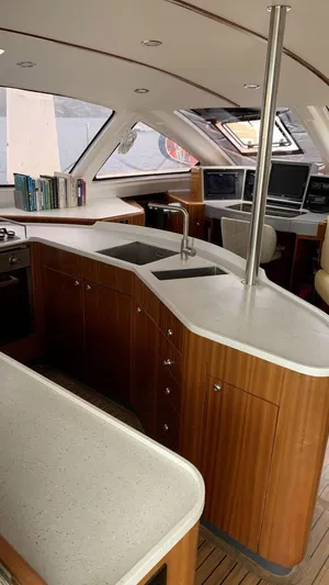 Mersea Yacht Photos Pics Luxurious interior of a 2001 Catana 582 yacht with modern kitchen and seating area.