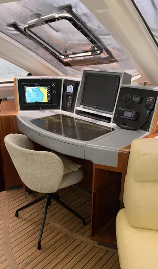 Mersea Yacht Photos Pics Navigation station of a 2001 Catana 582 yacht with modern equipment and comfortable seating.
