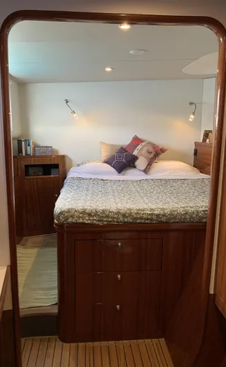 Mersea Yacht Photos Pics Luxurious cabin interior of 2001 Catana 582 yacht with cozy bed and wooden furnishings.