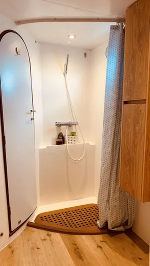 Mersea Yacht Photos Pics Catana 582 yacht bathroom with shower, wooden accents, and curtain, 2001 model.