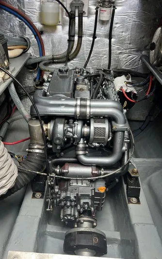 Mersea Yacht Photos Pics Engine compartment of a 2001 Catana 582, showcasing detailed mechanical components and wiring.