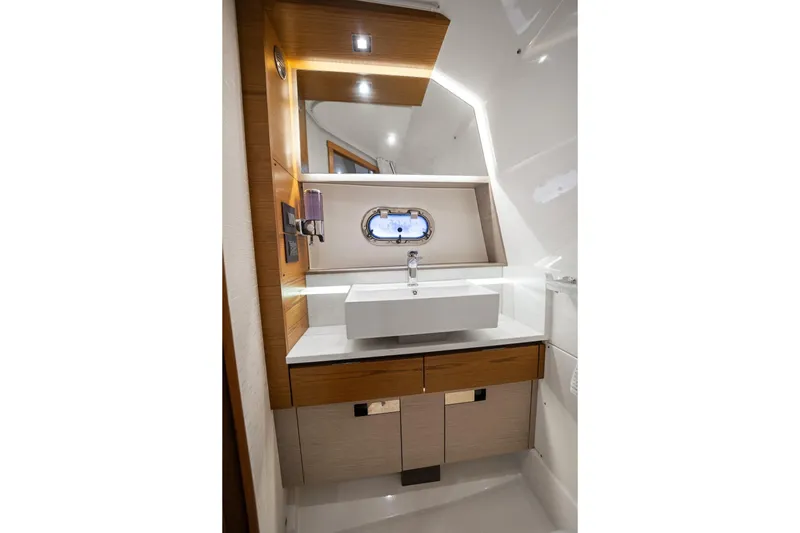 Twelve Yacht Photos Pics Luxurious 2022 Tiara Sport 43 LS yacht bathroom with modern sink and elegant wood accents.