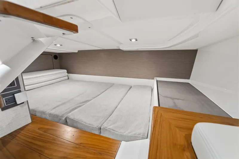 Twelve Yacht Photos Pics 2022 Tiara Sport 43 LS cabin interior with modern design and comfortable bedding.