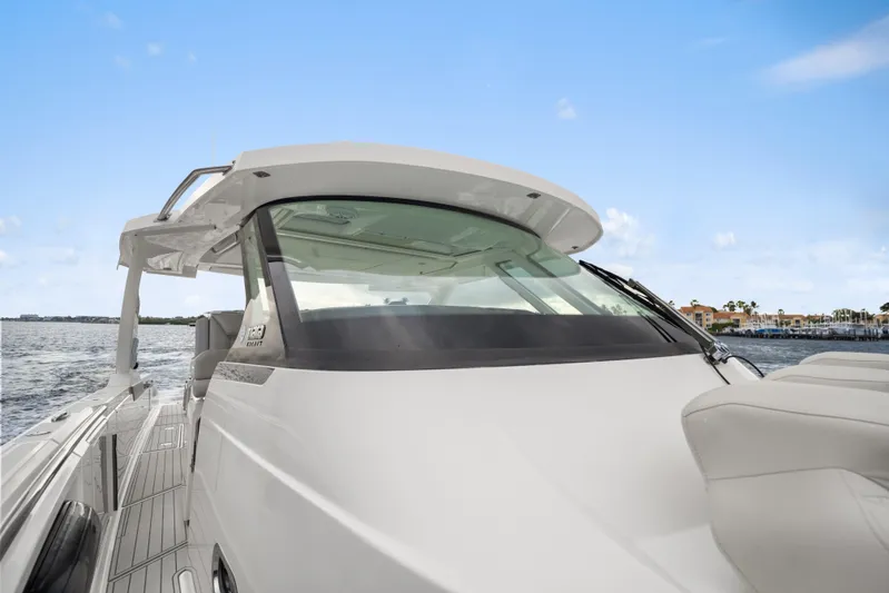 Twelve Yacht Photos Pics 2022 Tiara Sport 43 LS luxury boat on water, showcasing sleek design and spacious deck.