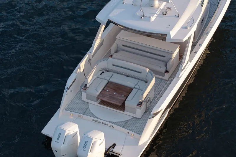 Twelve Yacht Photos Pics 2022 Tiara Sport 43 LS luxury yacht with spacious deck and seating, cruising on water.