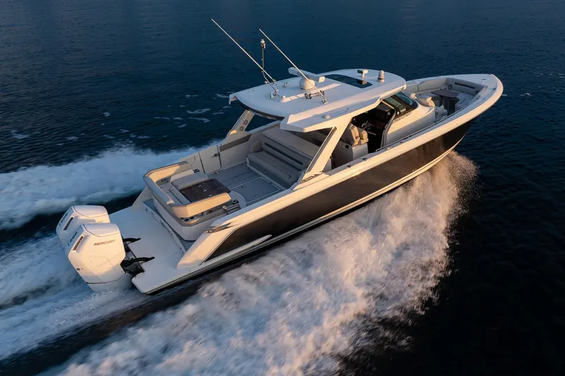 Twelve Yacht Photos Pics 2022 Tiara Sport 43 LS luxury boat cruising on open water.