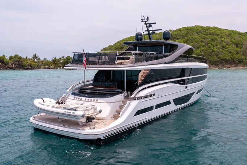Hang Loose Yacht Photos Pics Luxurious 2021 Princess X95 yacht anchored near tropical island, featuring sleek design and spacious deck.