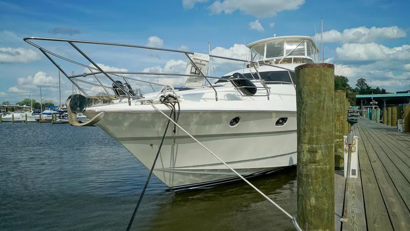 Laurie Lu Yacht Photos Pics Luxury 2002 Viking Princess 68 yacht docked at marina under blue sky.