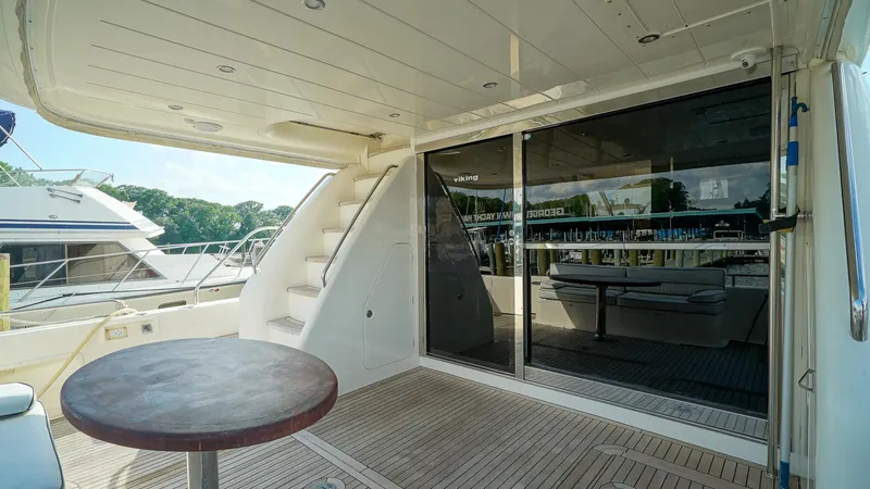 Laurie Lu Yacht Photos Pics Outdoor deck of 2002 Viking Princess 68 yacht with table and stairs.