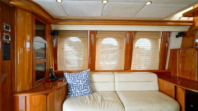 Laurie Lu Yacht Photos Pics Luxurious interior of 2002 Viking Princess 68 yacht with elegant wood finish and plush seating.