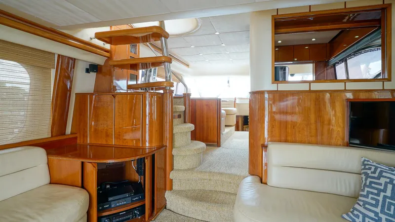 Laurie Lu Yacht Photos Pics Luxurious interior of 2002 Viking Princess 68 yacht with elegant wood finishes and plush seating.