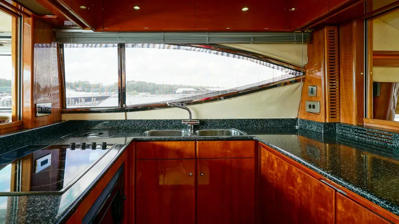 Laurie Lu Yacht Photos Pics Luxurious kitchen interior of 2002 Viking Princess 68 yacht with sleek countertops and modern appliances.