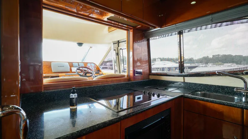Laurie Lu Yacht Photos Pics Luxurious kitchen interior of 2002 Viking Princess 68 yacht with sleek countertops and scenic window view.