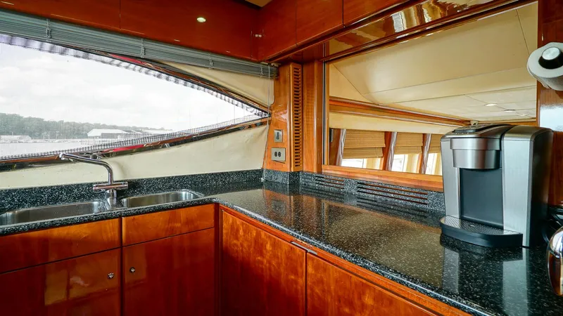 Laurie Lu Yacht Photos Pics Luxurious kitchen interior of 2002 Viking Princess 68 yacht with sleek countertops and modern appliances.