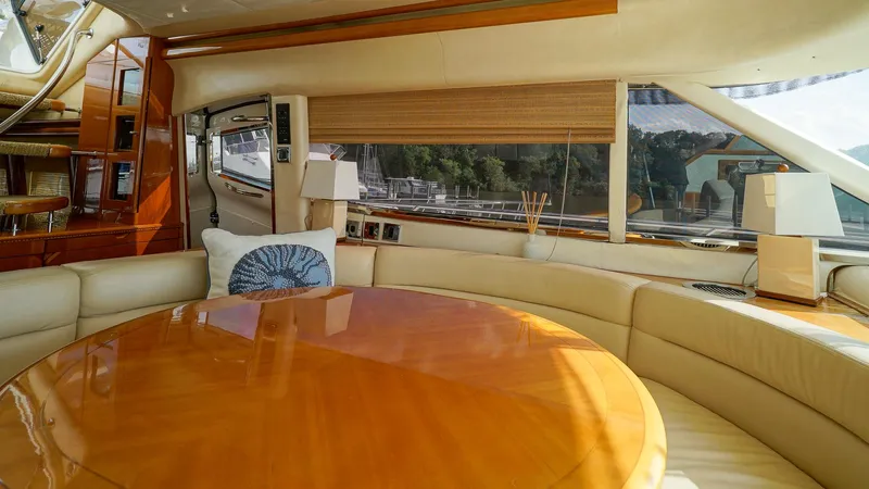 Laurie Lu Yacht Photos Pics Luxurious interior of 2002 Viking Princess 68 yacht with elegant wood table and plush seating.