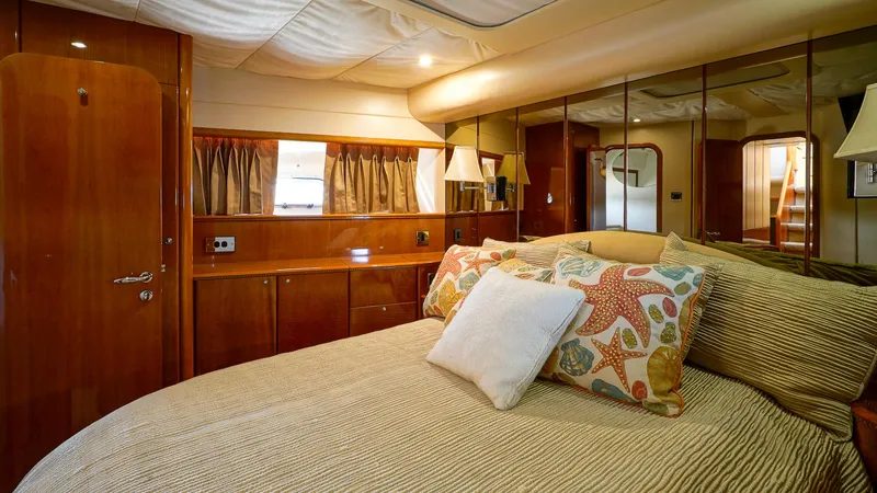 Laurie Lu Yacht Photos Pics Luxurious bedroom interior of 2002 Viking Princess 68 yacht with elegant wood finishes.