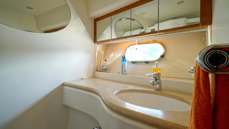 Laurie Lu Yacht Photos Pics Luxurious bathroom in 2002 Viking Princess 68 yacht with modern fixtures and oval window.