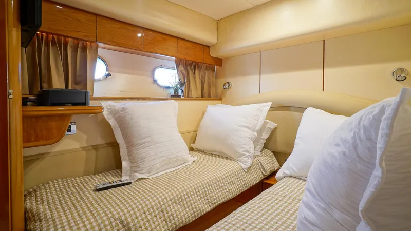 Laurie Lu Yacht Photos Pics Cozy twin cabin in 2002 Viking Princess 68 yacht with plush pillows and elegant decor.