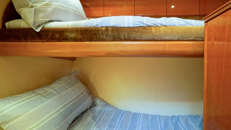 Laurie Lu Yacht Photos Pics Bunk beds in a 2002 Viking Princess 68 yacht cabin with striped bedding.