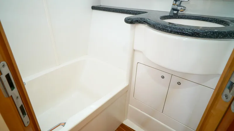 Laurie Lu Yacht Photos Pics Luxurious bathroom in 2002 Viking Princess 68 yacht with sleek sink and compact bathtub.