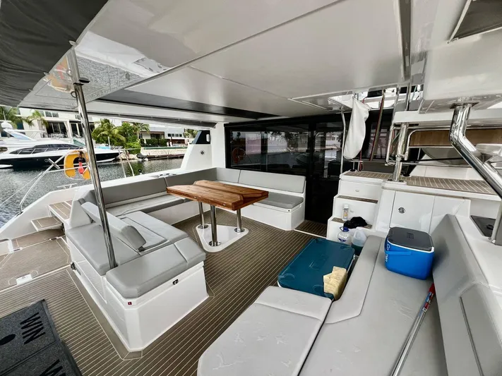 Win Win Yacht Photos Pics Spacious deck of 2022 Leopard 50 yacht with seating and table.