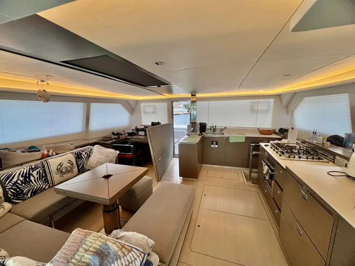 Win Win Yacht Photos Pics Luxurious interior of a 2022 Leopard 50 yacht with modern kitchen and seating area.