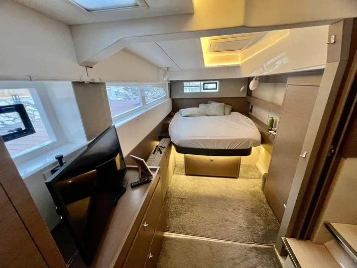 Win Win Yacht Photos Pics Luxurious interior of 2022 Leopard 50 yacht with modern bedroom and TV.