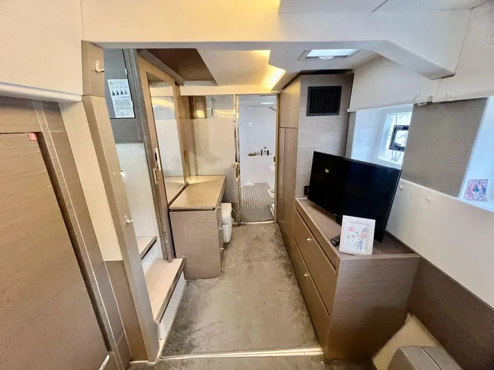 Win Win Yacht Photos Pics Luxurious interior of 2022 Leopard 50 yacht, featuring modern furnishings and a flat-screen TV.