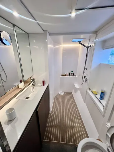 Win Win Yacht Photos Pics Modern bathroom interior on a 2022 Leopard 50 yacht, featuring sleek design and ample lighting.