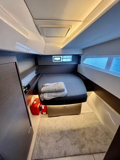 Win Win Yacht Photos Pics Cozy cabin interior of 2022 Leopard 50 yacht with bed and windows.