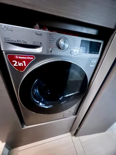 Win Win Yacht Photos Pics Front-loading LG washer-dryer combo with digital controls, 2-in-1 design, in a modern laundry space.