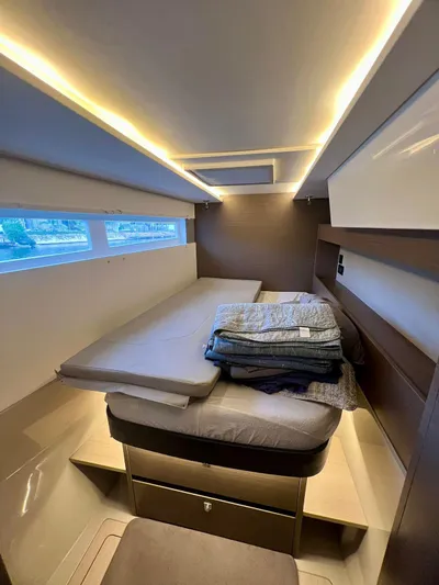 Win Win Yacht Photos Pics Luxurious cabin interior of 2022 Leopard 50 yacht with modern lighting and bedding.