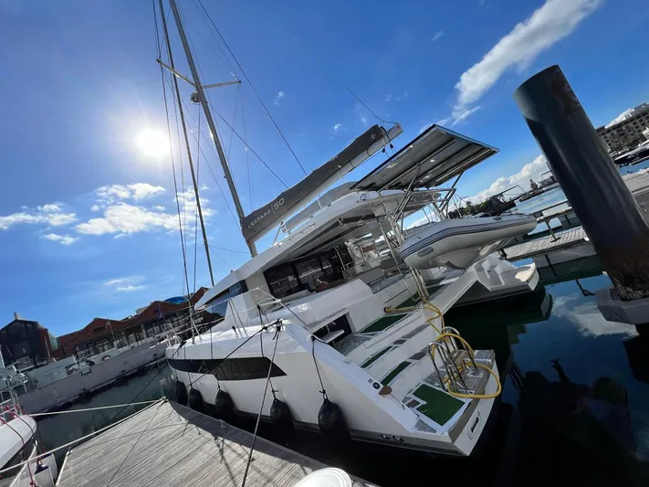 Win Win Yacht Photos Pics Modern Leopard 50 catamaran docked under a bright blue sky, 2022 model.