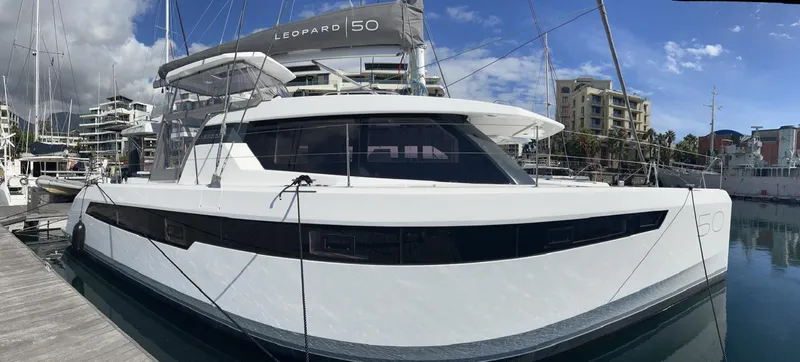 Win Win Yacht Photos Pics 2022 Leopard 50 catamaran docked at marina, showcasing sleek design and modern features.