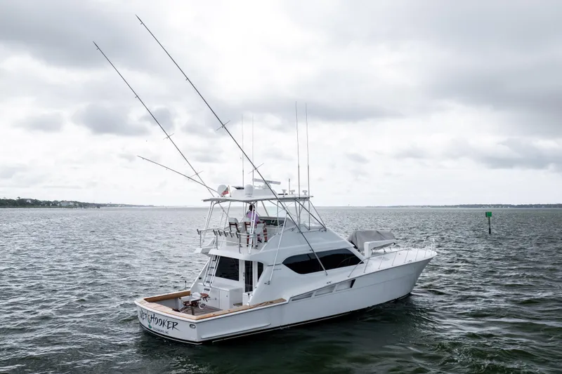 Wet Hooker Yacht Photos Pics 2003 Hatteras 60 Convertible yacht on open water under cloudy skies.