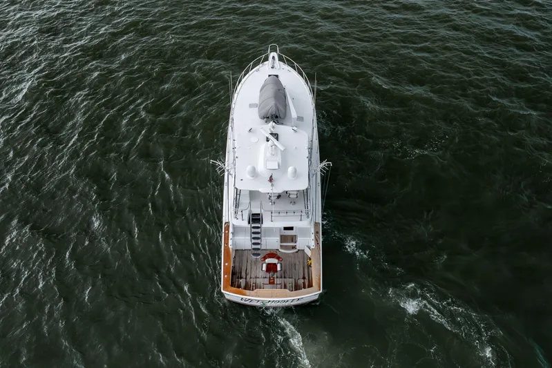 Wet Hooker Yacht Photos Pics Aerial view of 2003 Hatteras 60 Convertible yacht navigating through water.