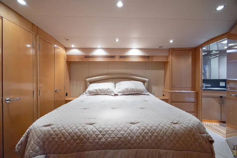 Wet Hooker Yacht Photos Pics Luxurious bedroom interior of 2003 Hatteras 60 Convertible yacht with elegant wood finishes.