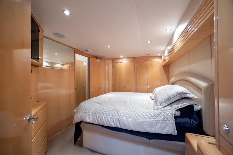 Wet Hooker Yacht Photos Pics Luxurious bedroom interior of 2003 Hatteras 60 Convertible yacht with elegant wood finishes.