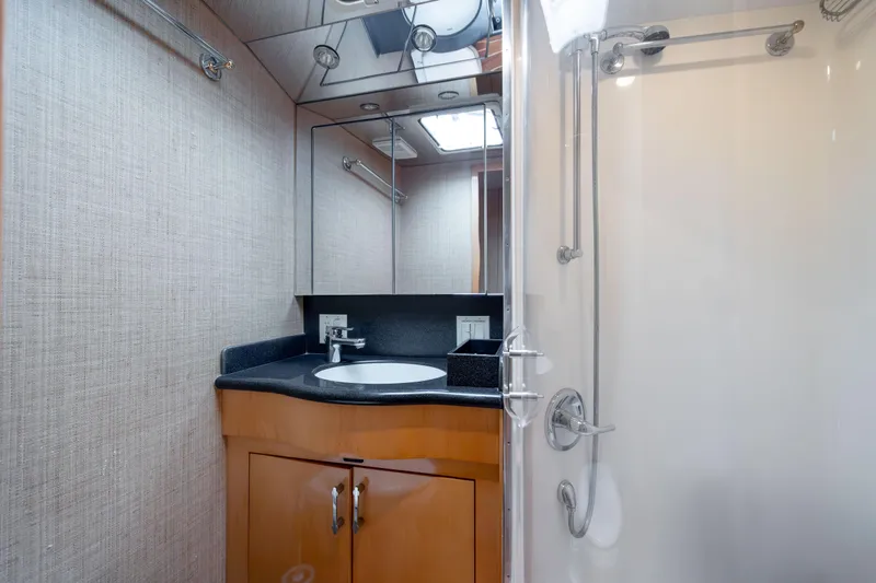 Wet Hooker Yacht Photos Pics Luxurious bathroom in 2003 Hatteras 60 Convertible yacht with modern fixtures and shower.