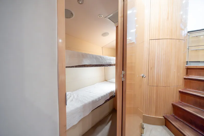 Wet Hooker Yacht Photos Pics Interior of 2003 Hatteras 60 Convertible yacht with bunk beds and wooden stairs.