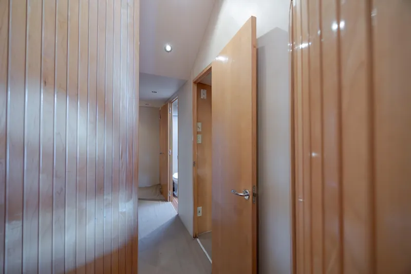 Wet Hooker Yacht Photos Pics Interior hallway of 2003 Hatteras 60 Convertible yacht with wooden doors and paneling.