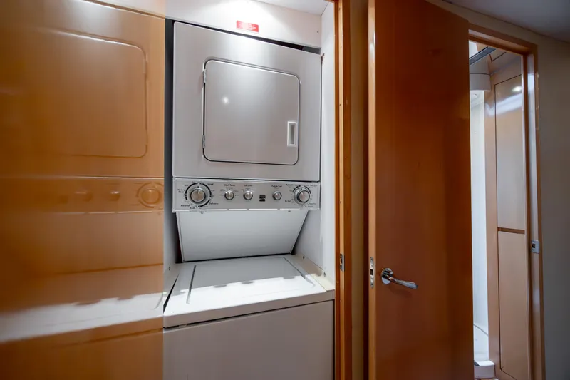 Wet Hooker Yacht Photos Pics Laundry area with stacked washer and dryer on 2003 Hatteras 60 Convertible yacht.