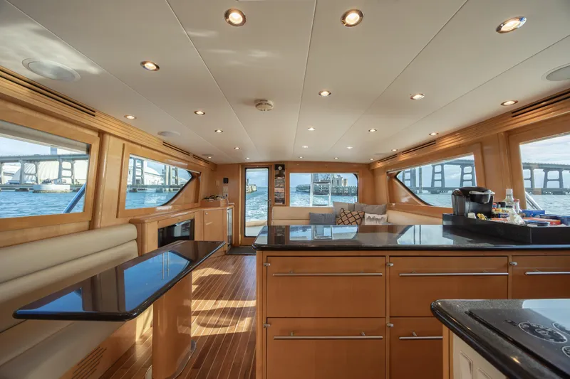 Wet Hooker Yacht Photos Pics Luxurious interior of 2003 Hatteras 60 Convertible yacht with elegant wood finishes and waterfront views.