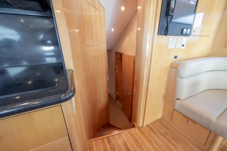 Wet Hooker Yacht Photos Pics Interior of 2003 Hatteras 60 Convertible yacht, featuring wooden stairs and modern design.