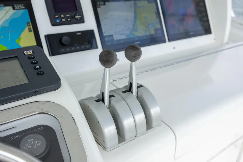 Wet Hooker Yacht Photos Pics Control panel of 2003 Hatteras 60 Convertible yacht with navigation screens and throttle levers.