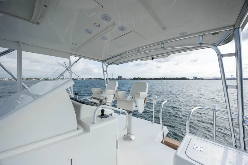 Wet Hooker Yacht Photos Pics 2003 Hatteras 60 Convertible yacht helm with ocean view and seating.