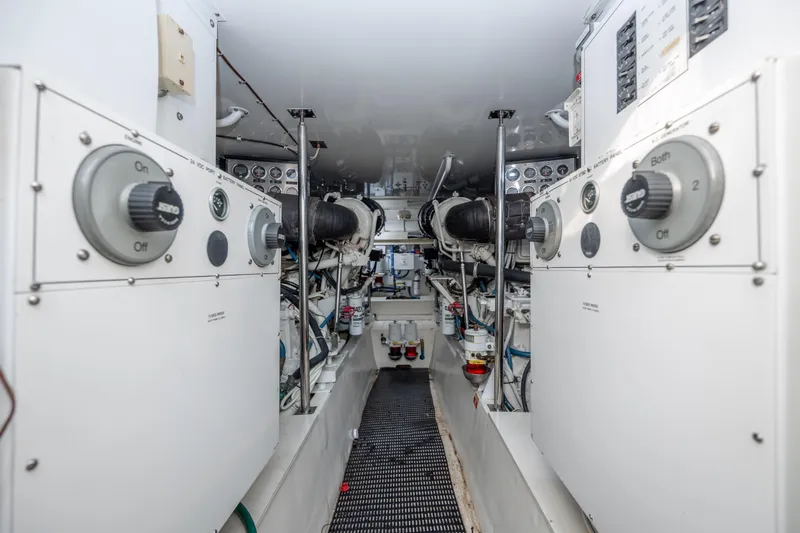 Wet Hooker Yacht Photos Pics Engine room of 2003 Hatteras 60 Convertible yacht, showcasing control panels and machinery.