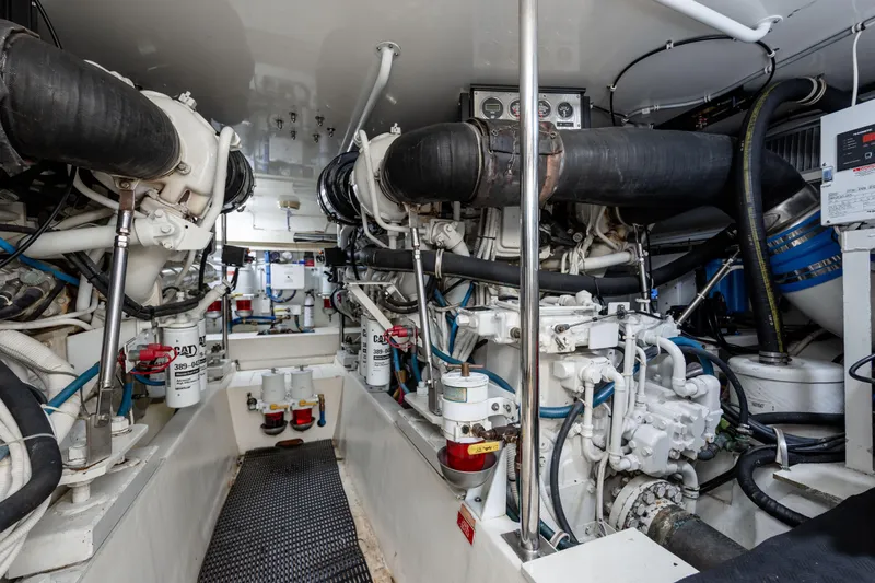 Wet Hooker Yacht Photos Pics Engine room of 2003 Hatteras 60 Convertible yacht, showcasing dual engines and mechanical systems.