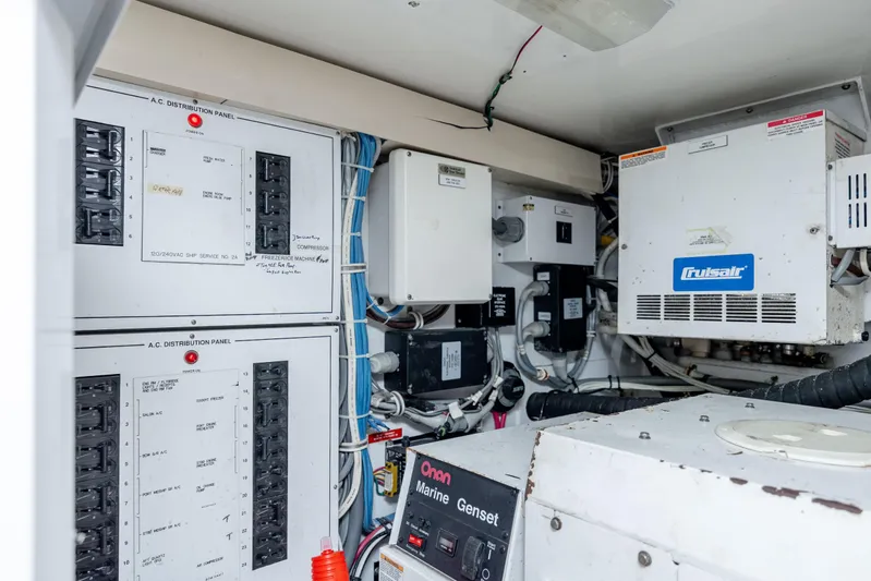 Wet Hooker Yacht Photos Pics Electrical control room of 2003 Hatteras 60 Convertible yacht, featuring distribution panels and equipment.